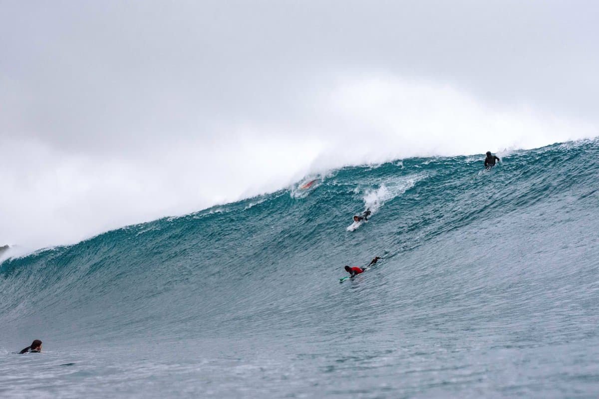 Brian Collins' dramatic water sports photograph showing surfer against massive wave with perfect water texture detail