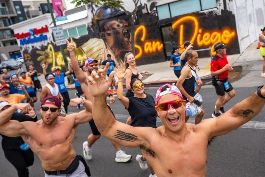Diego Rodriguez's atmospheric night photography of marathon runners illuminated by city lights