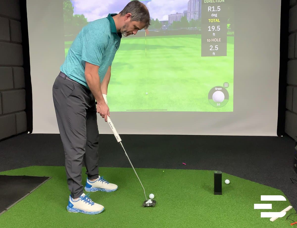 Rapsodo MLM2Pro launch monitor positioned behind golf ball with tablet showing comprehensive swing metrics