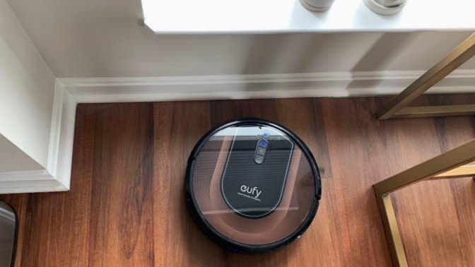 Robot vacuums lined up on wooden floor showing size comparison and design differences