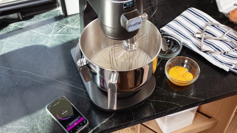 Modern smart stand mixers with digital displays and app connectivity on a kitchen counter