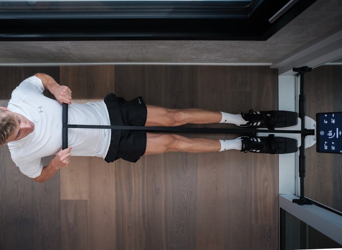 Compact rowing machine in home setting with tablet mount