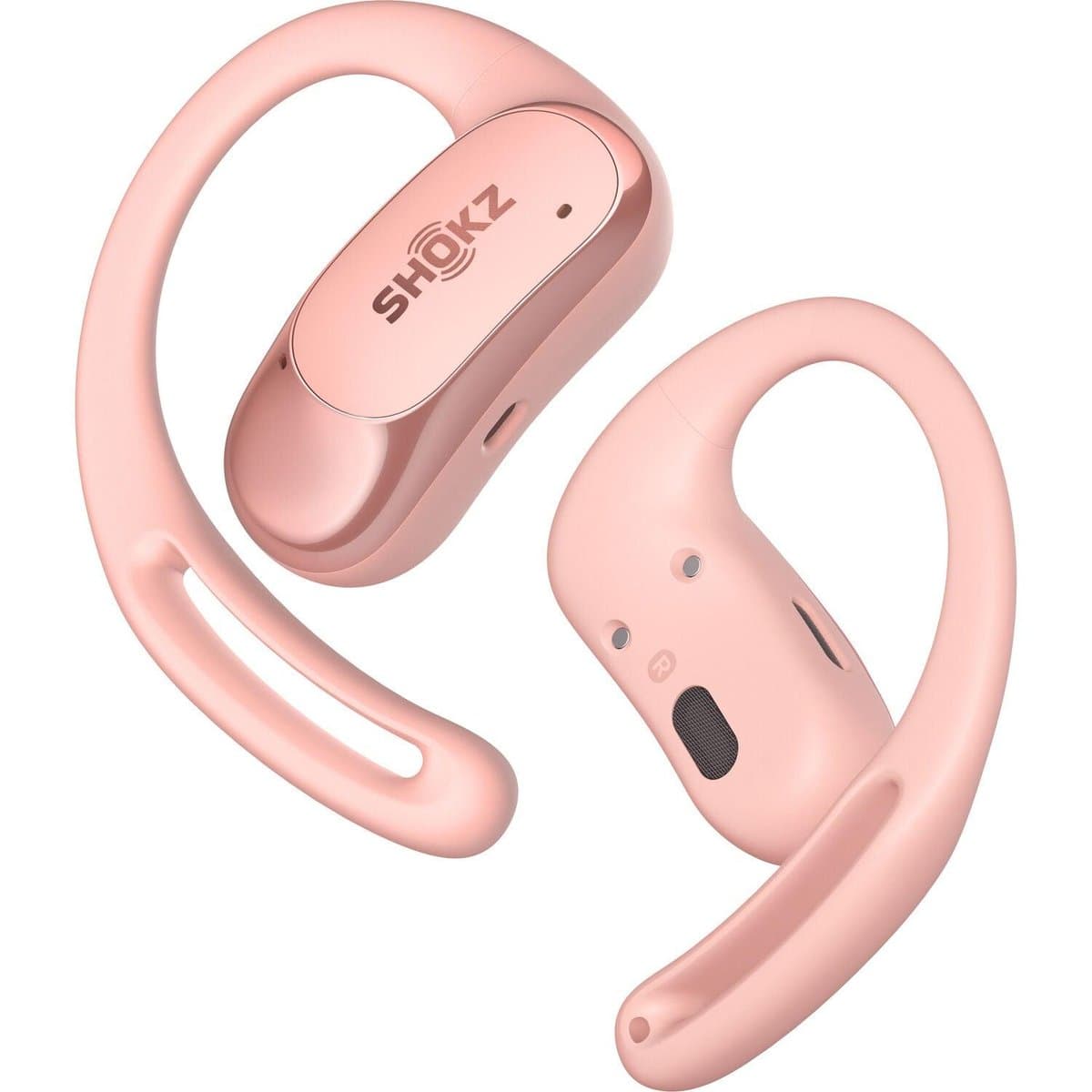 Shokz Openfit open-ear headphones in coral pink showing air conduction drivers