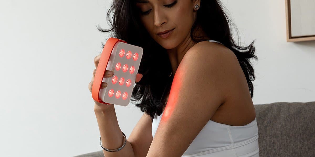 Handheld red light therapy device with interchangeable treatment heads