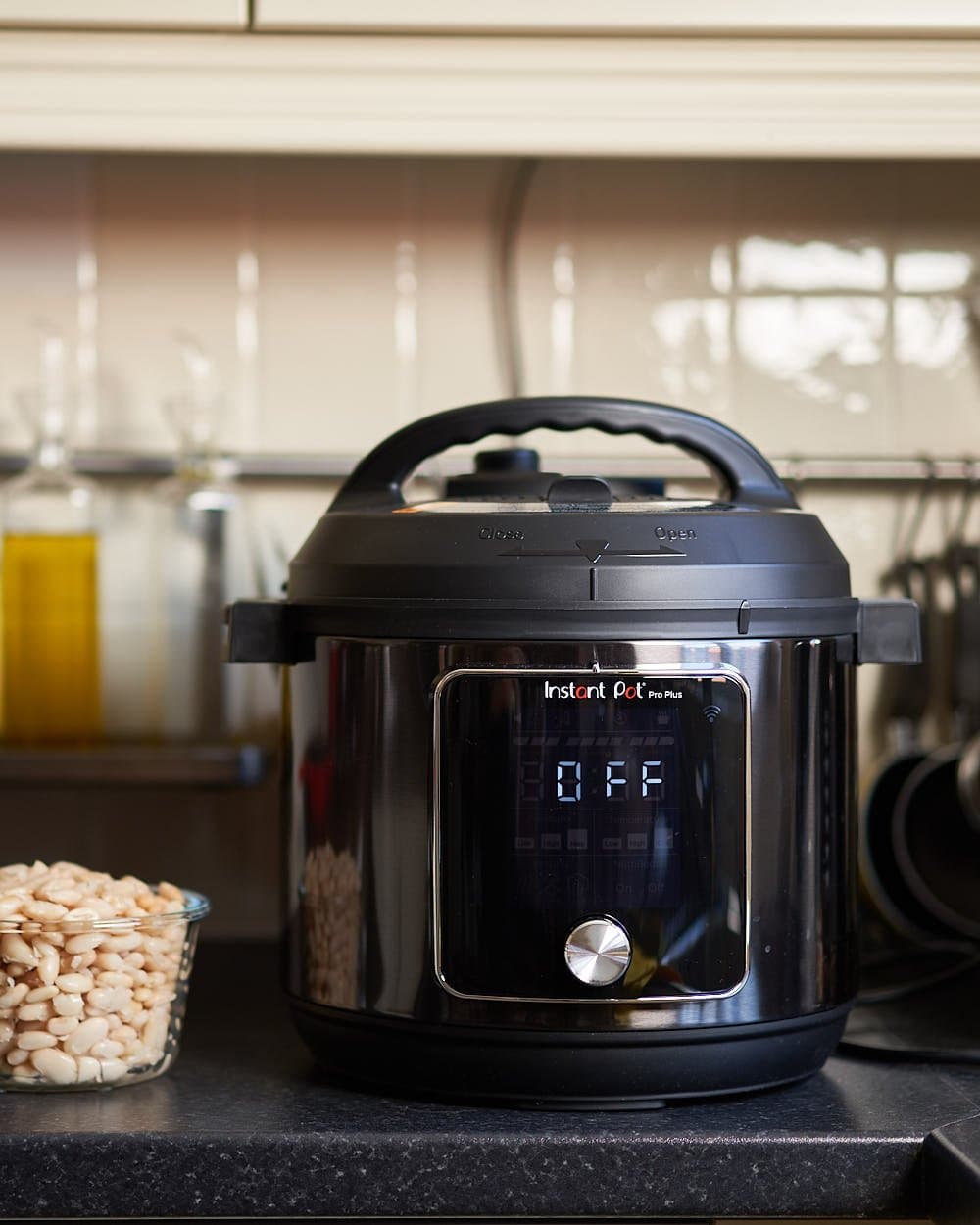 Instant Pot Duo Plus with smartphone showing cooking status