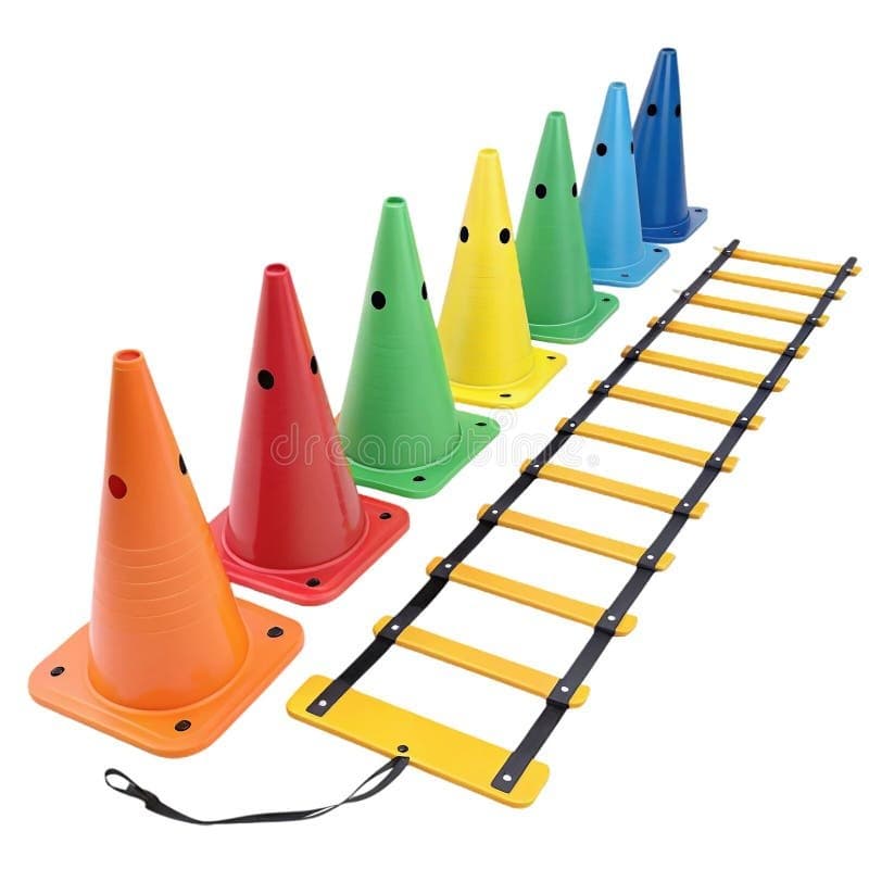 Colorful agility cones and speed ladder arranged in training pattern on grass field